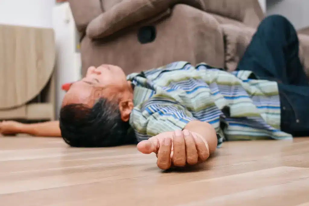 Older man lying on the floor, representing the physical toll of alcohol use and raising the question: what does alcohol do to your body over time?