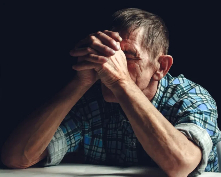 Older man in distress with head in hands, symbolizing the emotional and cognitive toll of long-term use and raising the question: what does Xanax do to the brain?